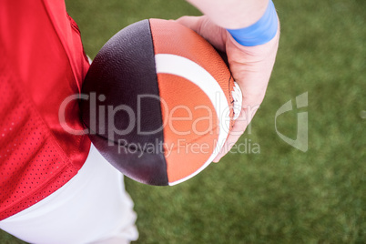 American football player holding the ball