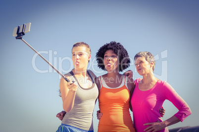 Sporty women posing and taking selfies with selfiestick