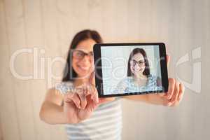 Pretty hipster taking selfie with tablet