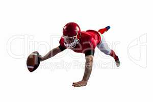 American football player reaching football