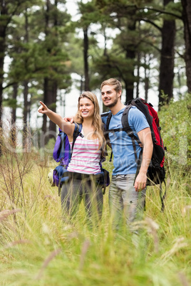 Young hiker couple pointing