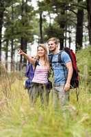 Young hiker couple pointing