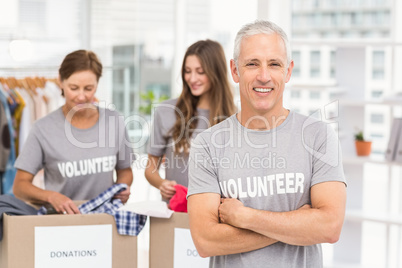 Smiling volunteer with arms crossed
