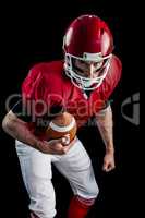 Portrait of focused american football player being ready to atta