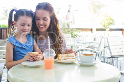 Mother and daughter at cafe terrace