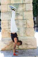 Handsome athlete doing a headstand