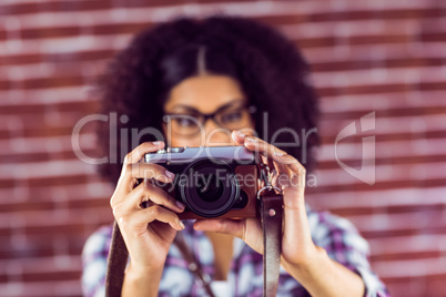 Attractive hipster taking pictures with camera