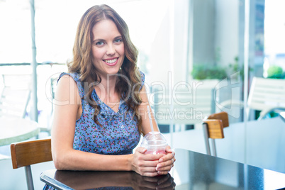 Pretty brunette having a smoothie