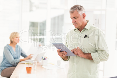 Attentive businessman working on the tablet