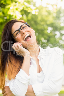 Beautiful brunette making a call in the park