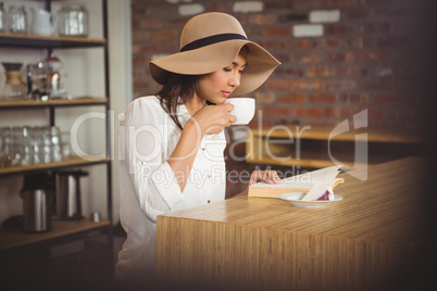 Beautiful businesswoman reading a book