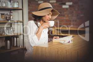 Beautiful businesswoman reading a book