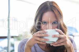 Pretty brunette enjoying a cappuccino