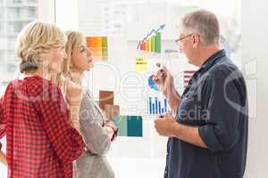 Attentive business team explaining flow charts