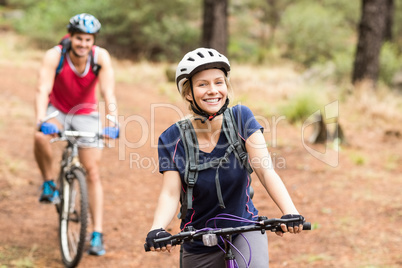 Happy young biker couple looking at camera