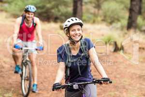 Happy young biker couple looking at camera