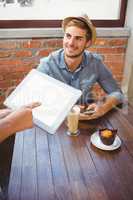 Waitress taking handsome hipsters order with tablet