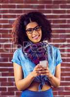 Smiling attractive hipster texting