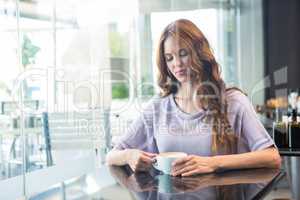 Pretty brunette enjoying a coffee