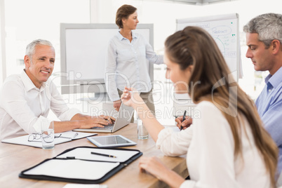 Smiling business people listening to presentation