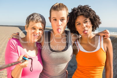 Sporty women posing and taking selfies with selfiestick