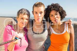 Sporty women posing and taking selfies with selfiestick