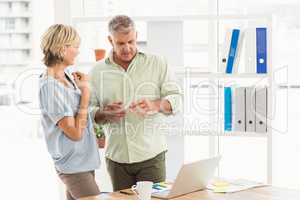 Attentive business team discussing over a laptop