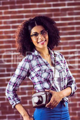 Attractive smiling hipster posing with camera