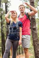 Young happy hiker couple looking away