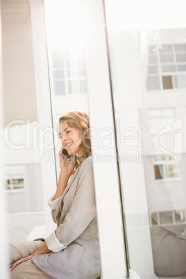 Smiling casual businesswoman having a phone call