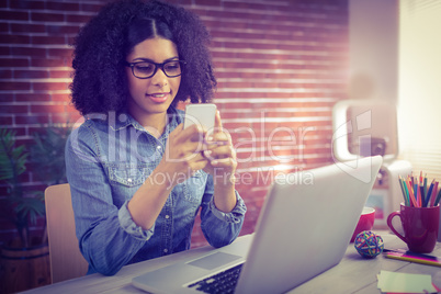 Casual businesswoman using her smartphone