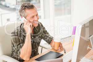 Smiling casual businessman having a phone call
