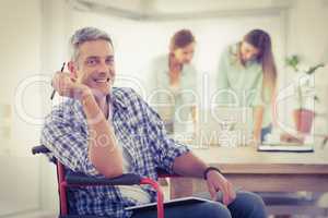 Smiling casual businessman in wheelchair
