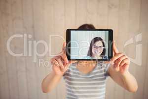 Pretty hipster taking selfie with tablet