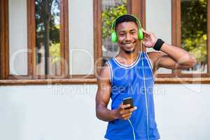 An handsome athlete listening to music