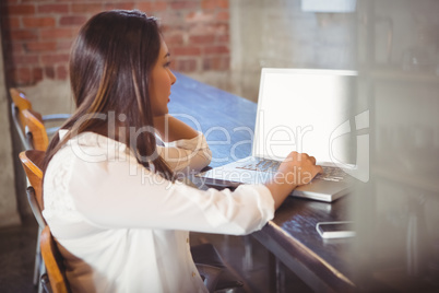 Beautiful businesswoman reading a book