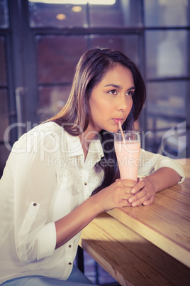 A beautiful woman drinking a hot chocolate