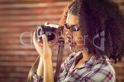 Attractive hipster photographing with camera