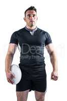 Tough rugby player holding ball