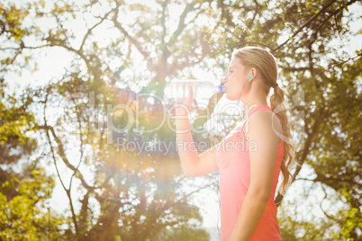 Blonde athlete drinking water out of bottle
