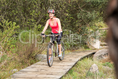 Smiling blonde athlete mountain biking