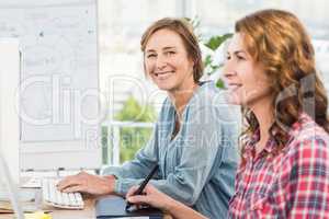 Casual businesswomen looking at computer