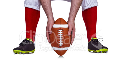 American football player placing the ball