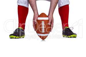 American football player placing the ball