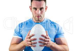 Rugby player looking at camera with ball