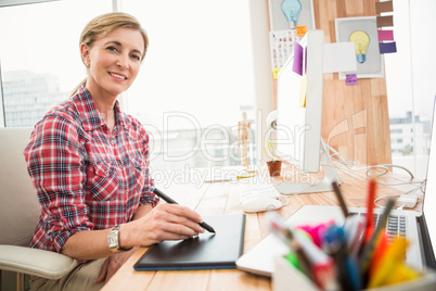 Smiling casual designer working with digitizer