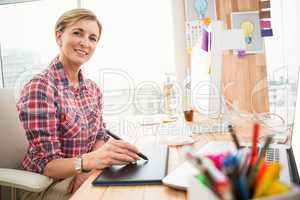 Smiling casual designer working with digitizer