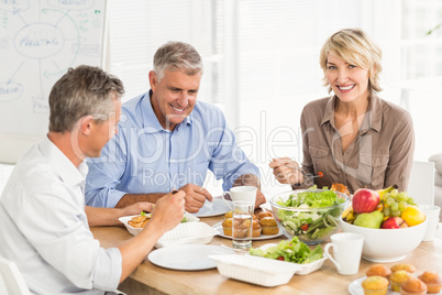 Smiling business colleagues having lunch together