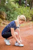 Athletic blonde tying her shoelace