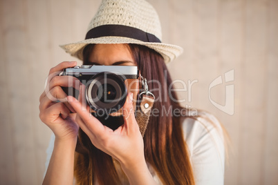 Pretty hipster using her vintage camera